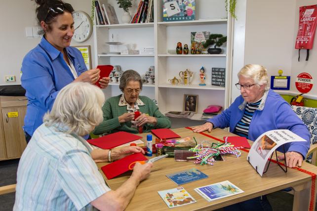 Carer having a joyful exchange with residents