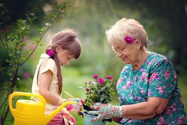 Child with elderly woman in the garden