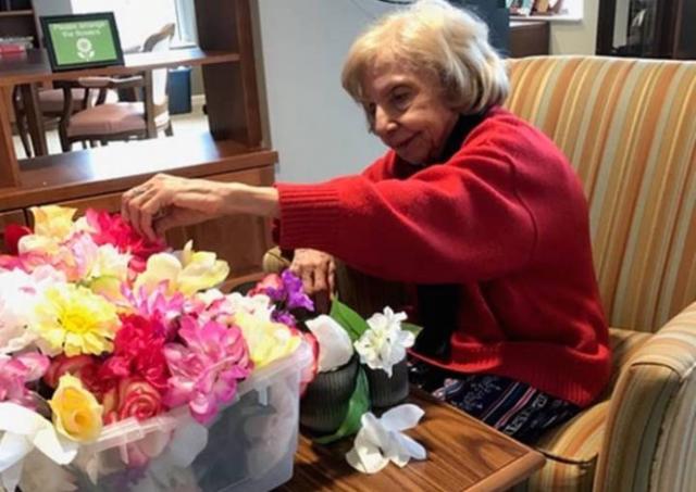 Elderly woman flower arranging