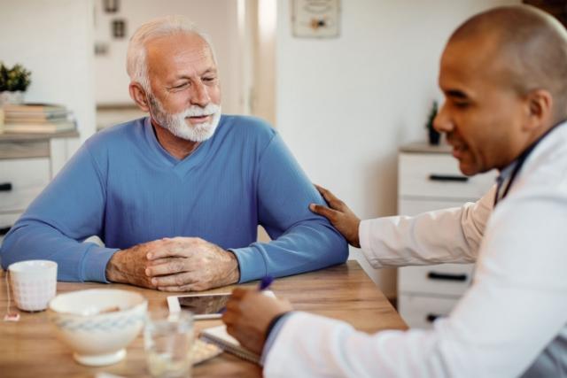 Elderly man talking with doctor