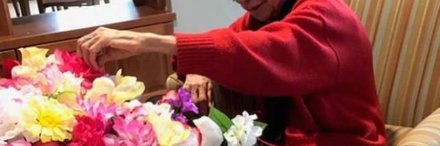 Elderly woman flower arranging