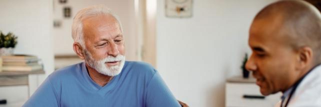 Elderly man talking with doctor