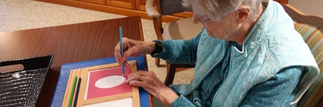 Elderly care resident using Montessori materials